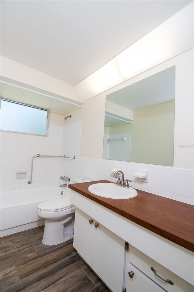 3406 Rock Royal Dr, Holiday, FL 34691 - bathroom with vanity,  shower combination, wood finished floors, and tile walls