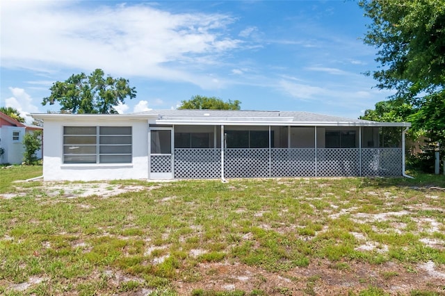 3406 Rock Royal Dr, Holiday, FL 34691 - rear view of property with a sunroom and a yard