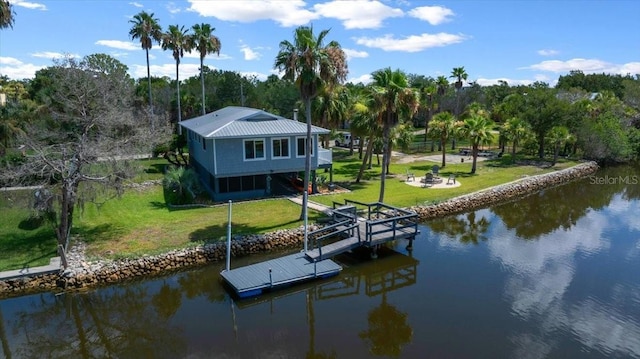 12046 W Gulf Breeze Ct, Crystal River, FL 34429 - dock with a water view, a lawn, and an outdoor fire pit