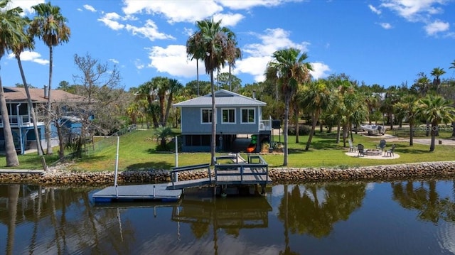 12046 W Gulf Breeze Ct, Crystal River, FL 34429 - dock area with a water view, a fire pit, and a lawn