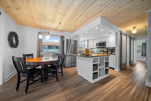 12046 W Gulf Breeze Ct, Crystal River, FL 34429 - dining room featuring wood ceiling, a barn door, plenty of natural light, a chandelier, and recessed lighting