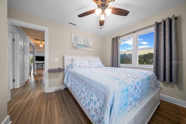 12046 W Gulf Breeze Ct, Crystal River, FL 34429 - bedroom featuring wood finished floors, ceiling fan, and attic access