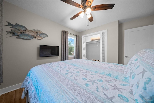 12046 W Gulf Breeze Ct, Crystal River, FL 34429 - bedroom with wood finished floors, ceiling fan, and a closet