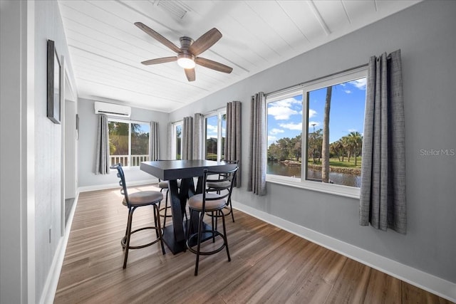 12046 W Gulf Breeze Ct, Crystal River, FL 34429 - dining area featuring a wall mounted AC, wood finished floors, a ceiling fan, a water view, and wood ceiling