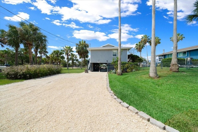 12046 W Gulf Breeze Ct, Crystal River, FL 34429 - view of front of house with dirt driveway and a carport