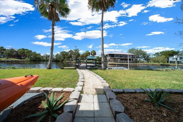 12046 W Gulf Breeze Ct, Crystal River, FL 34429 - view of green lawn with a water view, boat lift, and a dock