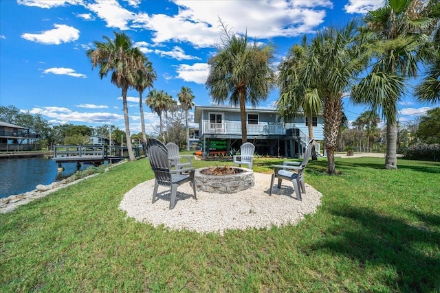 12046 W Gulf Breeze Ct, Crystal River, FL 34429 - view of green lawn with a fire pit, a water view, and stairs