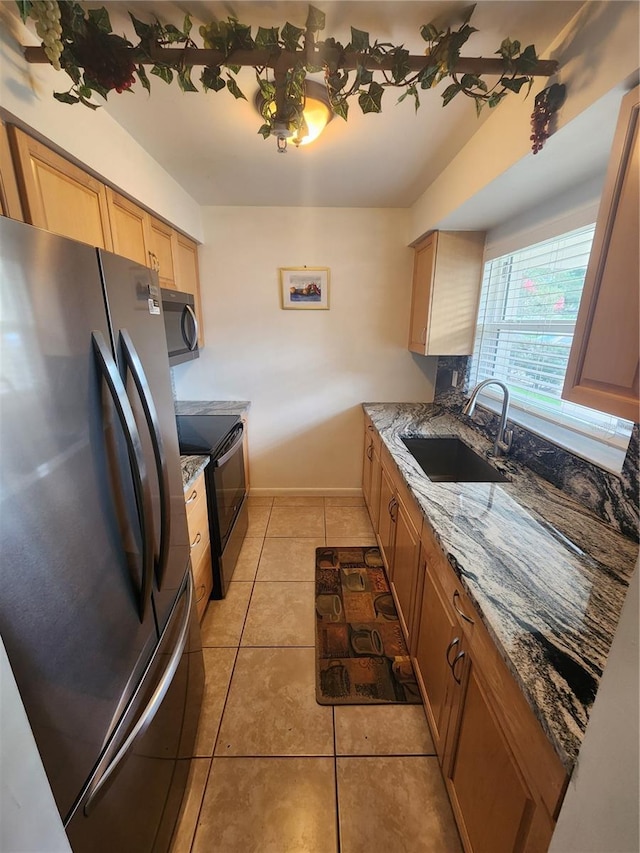 1975 W Bay Dr Unit 304, Largo, FL 33770 - kitchen with freestanding refrigerator, stainless steel microwave, range with electric stovetop, light tile patterned flooring, and stone counters
