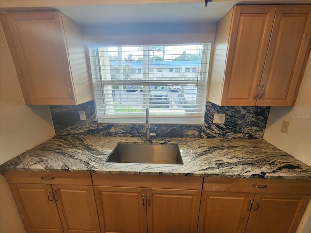 1975 W Bay Dr Unit 304, Largo, FL 33770 - kitchen with decorative backsplash, light stone countertops, and brown cabinets