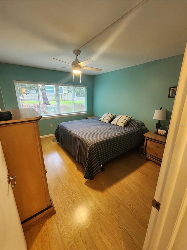 1975 W Bay Dr Unit 304, Largo, FL 33770 - bedroom featuring light wood-type flooring and a ceiling fan