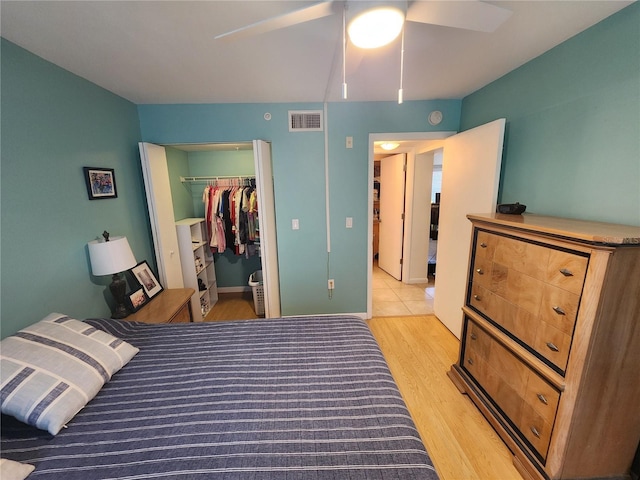 1975 W Bay Dr Unit 304, Largo, FL 33770 - bedroom featuring light wood finished floors, a spacious closet, a closet, and ceiling fan