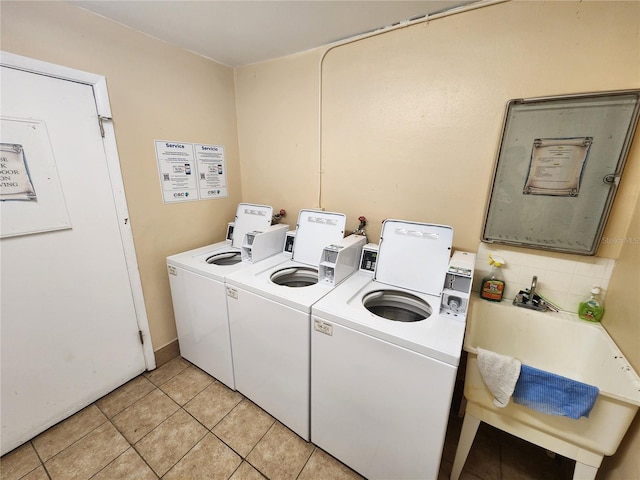1975 W Bay Dr Unit 304, Largo, FL 33770 - communal laundry room with light tile patterned flooring and independent washer and dryer