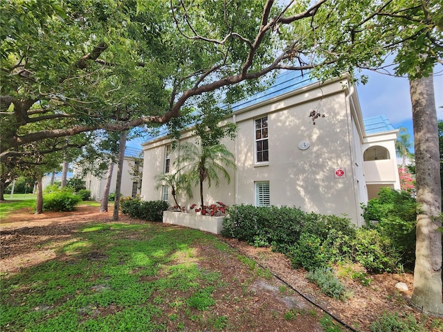 1975 W Bay Dr Unit 304, Largo, FL 33770 - view of side of home featuring stucco siding