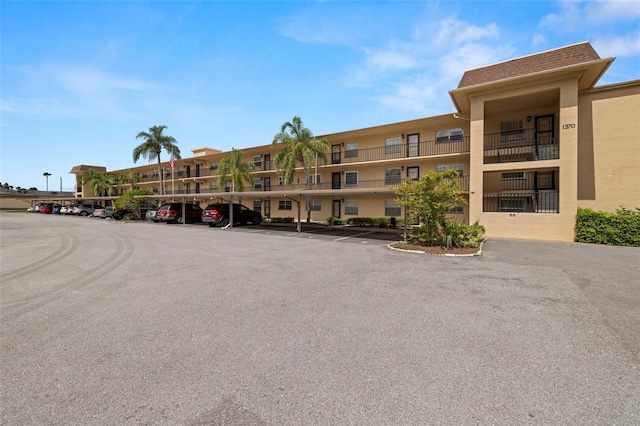 1370 Heather Ridge Blvd Unit 105, Dunedin, FL 34698 - view of property with covered and uncovered parking