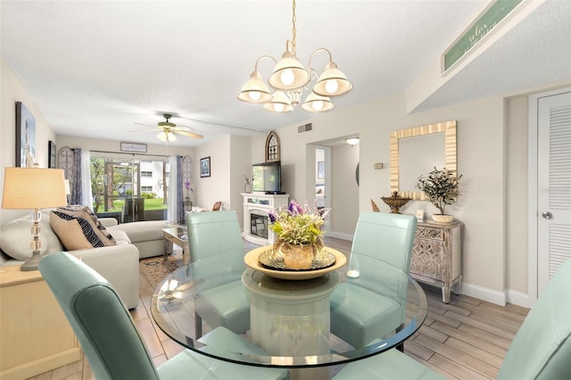 1370 Heather Ridge Blvd Unit 105, Dunedin, FL 34698 - dining area featuring a chandelier, light wood-style flooring, and a ceiling fan