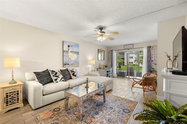 1370 Heather Ridge Blvd Unit 105, Dunedin, FL 34698 - living room featuring wood tiled floors, a ceiling fan, and a textured ceiling