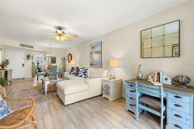 1370 Heather Ridge Blvd Unit 105, Dunedin, FL 34698 - living area with a ceiling fan, light wood-style flooring, and a chandelier