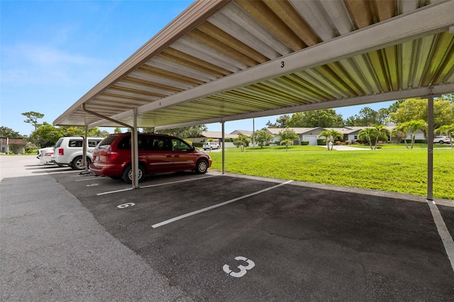 1370 Heather Ridge Blvd Unit 105, Dunedin, FL 34698 - covered parking lot featuring a residential view