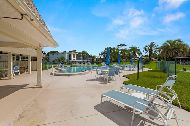 1370 Heather Ridge Blvd Unit 105, Dunedin, FL 34698 - community pool featuring a patio area and ceiling fan
