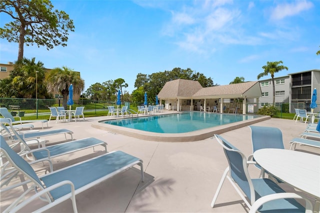 1370 Heather Ridge Blvd Unit 105, Dunedin, FL 34698 - community pool featuring a patio