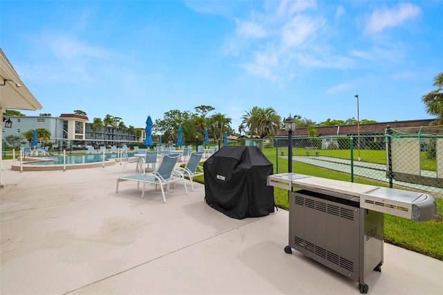 1370 Heather Ridge Blvd Unit 105, Dunedin, FL 34698 - view of patio featuring area for grilling and a community pool