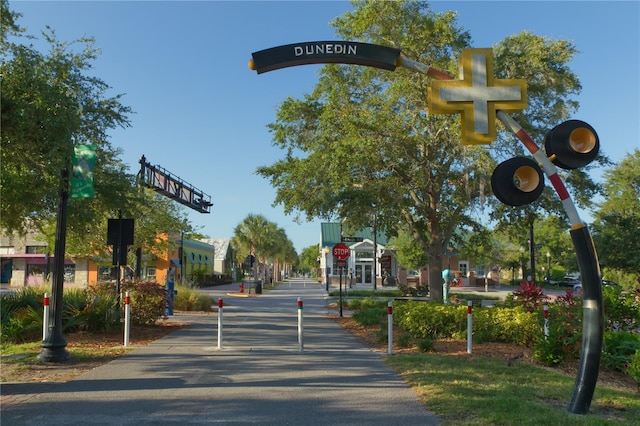 1370 Heather Ridge Blvd Unit 105, Dunedin, FL 34698 - view of asphalt road featuring traffic signs and traffic lights