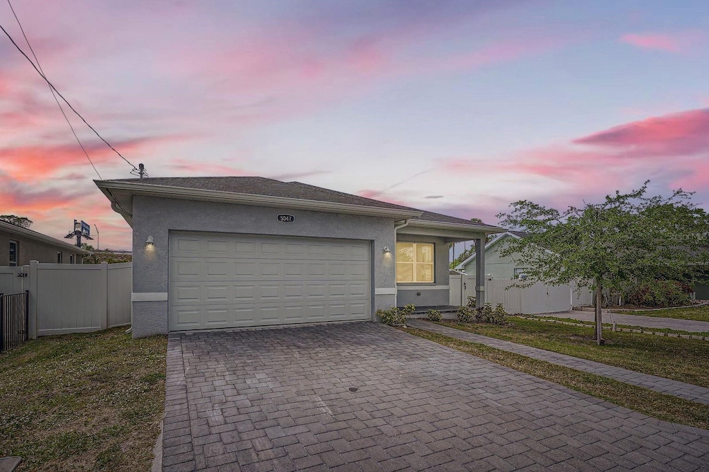 5047 23rd St N, Saint Petersburg, FL 33714 - ranch-style home with decorative driveway, stucco siding, and an attached garage