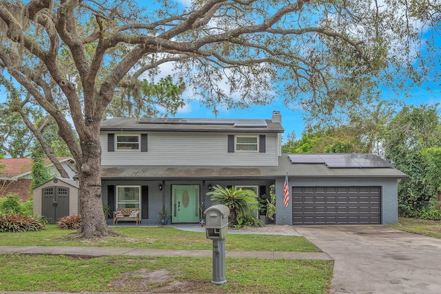 3731 Southview Dr, Brandon, FL 33511 - traditional home featuring roof mounted solar panels, a garage, brick siding, and covered porch