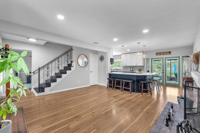 3731 Southview Dr, Brandon, FL 33511 - living area with light wood finished floors, recessed lighting, french doors, and stairs
