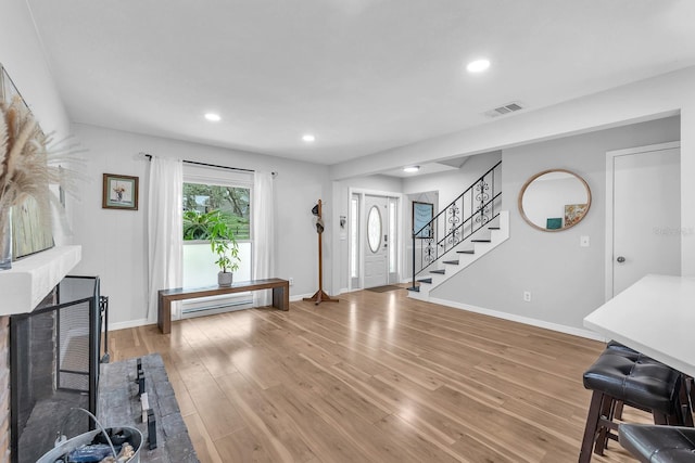 3731 Southview Dr, Brandon, FL 33511 - entryway with stairs, light wood-type flooring, recessed lighting, and a fireplace with raised hearth