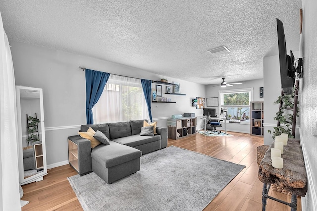 3731 Southview Dr, Brandon, FL 33511 - living room featuring a desk, wood finished floors, a ceiling fan, and a textured ceiling