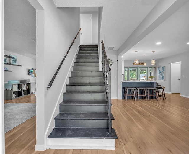 3731 Southview Dr, Brandon, FL 33511 - stairs with wood finished floors, recessed lighting, and a textured ceiling