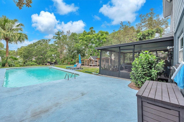 3731 Southview Dr, Brandon, FL 33511 - outdoor pool with a patio, a sunroom, and view of wooded area