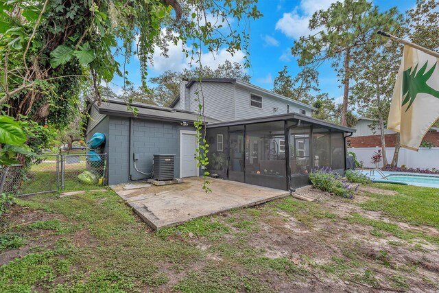 3731 Southview Dr, Brandon, FL 33511 - rear view of house featuring a sunroom, a patio area, a fenced backyard, a gate, and concrete block siding
