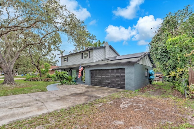 3731 Southview Dr, Brandon, FL 33511 - traditional-style home with an attached garage, solar panels, a chimney, driveway, and brick siding