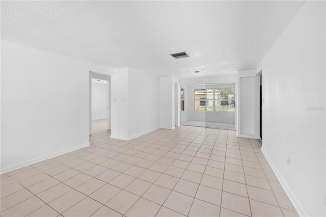 4923 Avery Rd, New Port Richey, FL 34652 - spare room with a textured ceiling and light tile patterned flooring