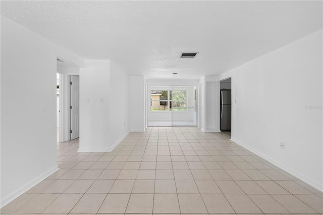 4923 Avery Rd, New Port Richey, FL 34652 - unfurnished room with a textured ceiling and light tile patterned flooring