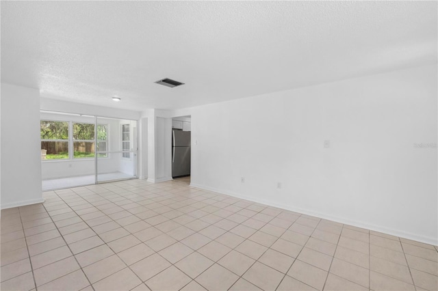 4923 Avery Rd, New Port Richey, FL 34652 - spare room featuring a textured ceiling and baseboards
