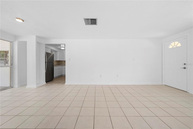 4923 Avery Rd, New Port Richey, FL 34652 - unfurnished room with baseboards and light tile patterned flooring