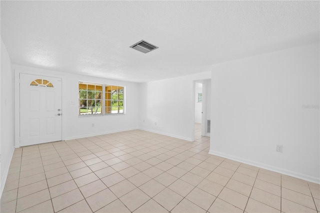4923 Avery Rd, New Port Richey, FL 34652 - entryway with a textured ceiling and light tile patterned floors