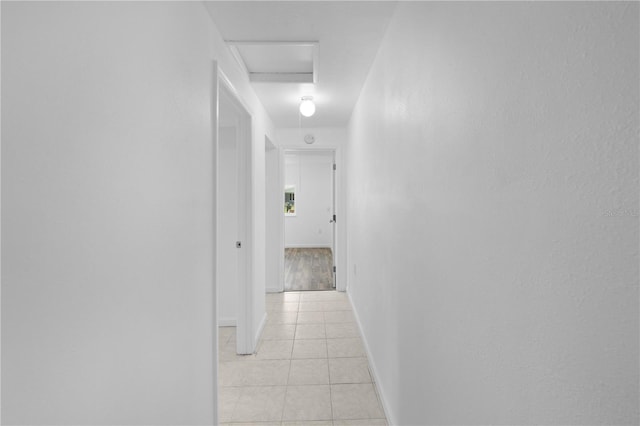 4923 Avery Rd, New Port Richey, FL 34652 - hallway with light tile patterned floors and attic access
