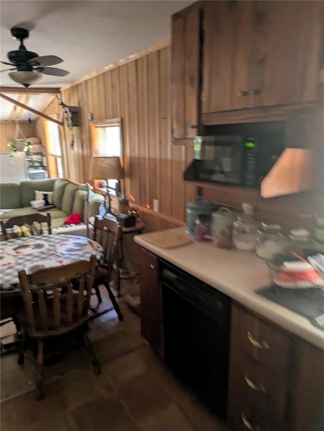 2833 SW Wilson Springs Rd, Fort White, FL 32038 - kitchen featuring wooden walls, ceiling fan, and light countertops