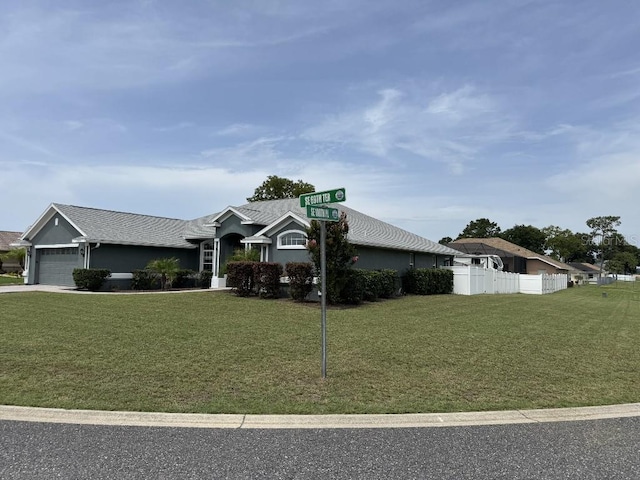10080 SE 69th Ter, Belleview, FL 34420 - view of front of house featuring a garage, stucco siding, and driveway