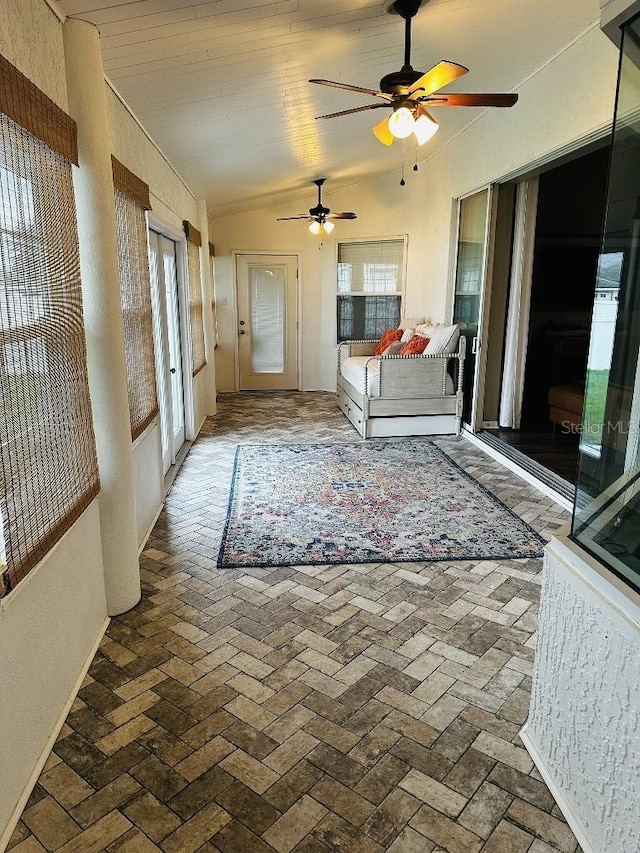 10080 SE 69th Ter, Belleview, FL 34420 - unfurnished bedroom featuring multiple windows, brick flooring, vaulted ceiling, and ceiling fan