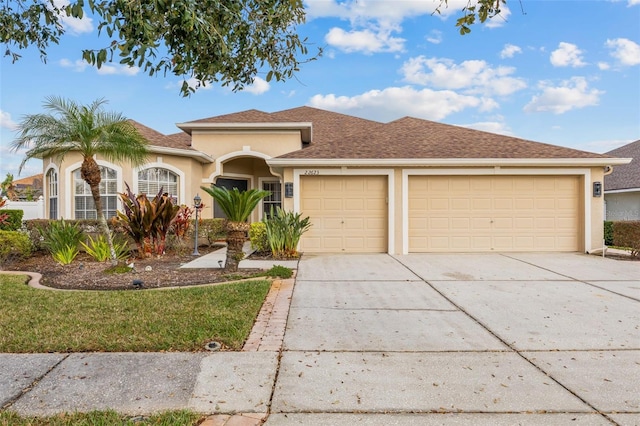 22623 Cliffside Way, Land O Lakes, FL 34639 - view of front of home featuring stucco siding, an attached garage, and concrete driveway