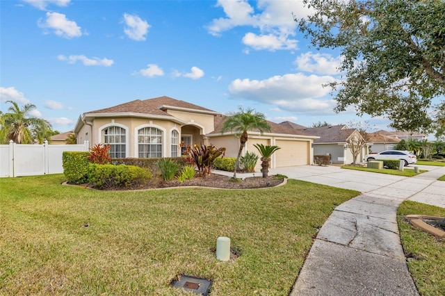 22623 Cliffside Way, Land O Lakes, FL 34639 - mediterranean / spanish house featuring stucco siding, an attached garage, and driveway