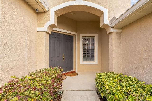 22623 Cliffside Way, Land O Lakes, FL 34639 - doorway to property with a surveillance system and stucco siding