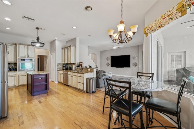 22623 Cliffside Way, Land O Lakes, FL 34639 - dining room with a chandelier, recessed lighting, light wood-style flooring, and arched walkways