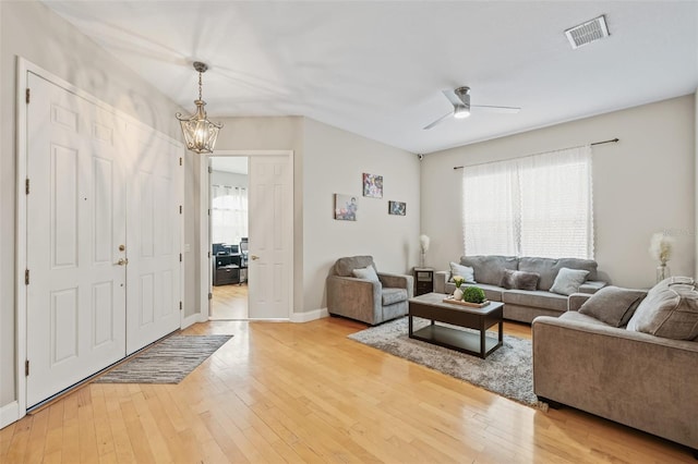 22623 Cliffside Way, Land O Lakes, FL 34639 - living room with light wood-style flooring, a ceiling fan, a chandelier, and vaulted ceiling