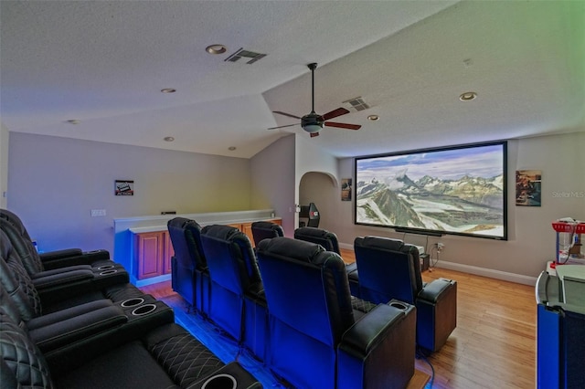 22623 Cliffside Way, Land O Lakes, FL 34639 - cinema room with light wood-style flooring, vaulted ceiling, a ceiling fan, a textured ceiling, and recessed lighting